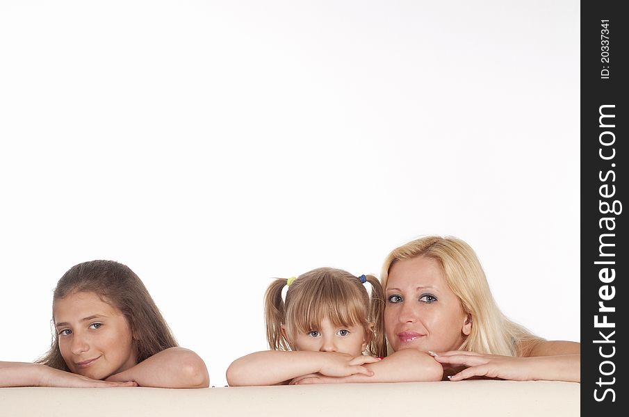 Three girls posing on a white background. Three girls posing on a white background