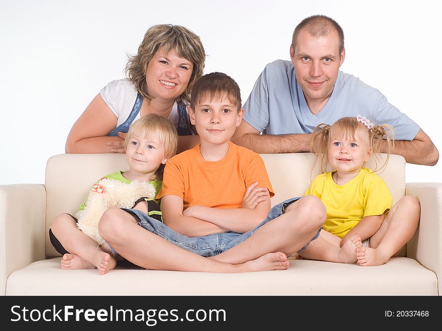 Portrit of a family sitting on sofa. Portrit of a family sitting on sofa