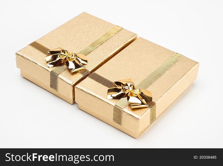 A pair of golden jewelry box isolated on white background