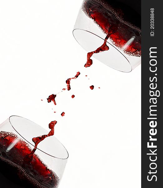 Cross full red wine glasses with red wine splash. Cross full red wine glasses with red wine splash.