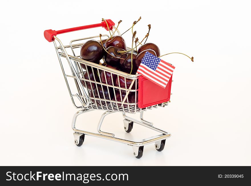 Red cherry in a shopping cart. Red cherry in a shopping cart