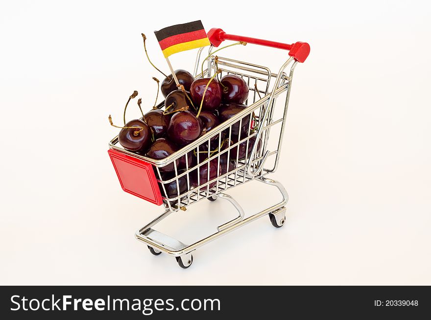 Red cherry in a shopping cart. Red cherry in a shopping cart