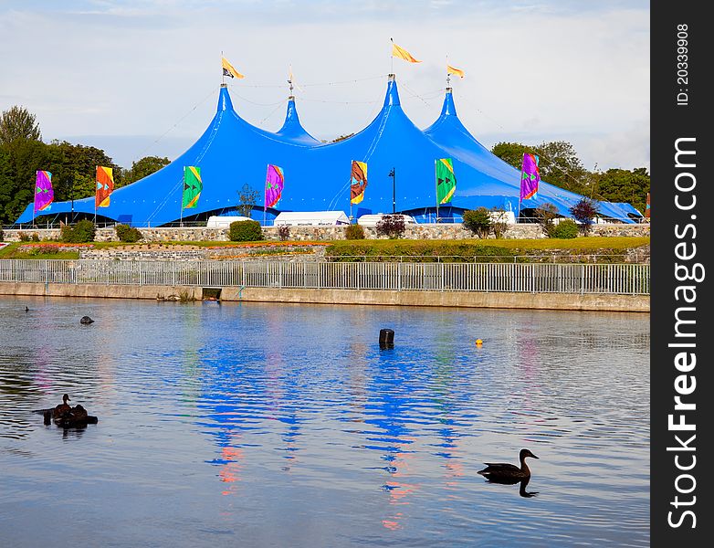 Circus Style Blue Tent On The Bank Of The River