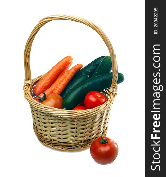 Vegetables in wicker basket on white