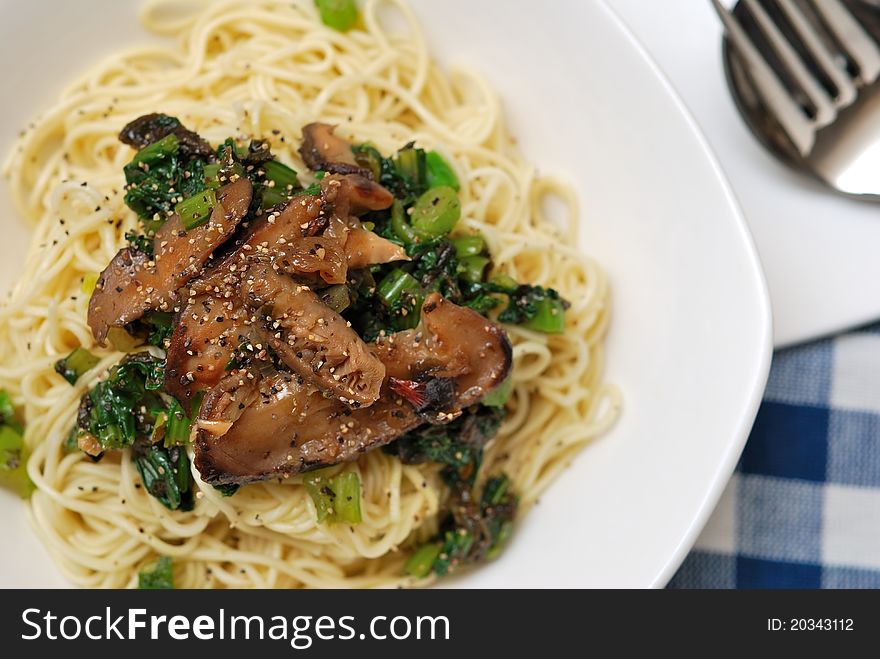 Yellow noodles served with generous topping of black mushrooms and sprinkled with black pepper. Yellow noodles served with generous topping of black mushrooms and sprinkled with black pepper.