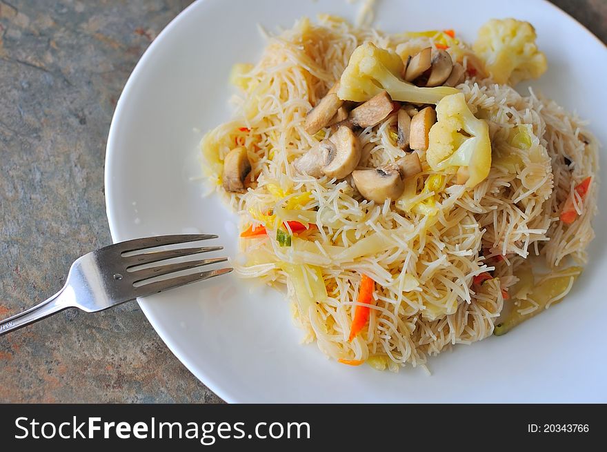 Vegetarian noodles prepared with healthy ingredients with fork. Vegetarian noodles prepared with healthy ingredients with fork.
