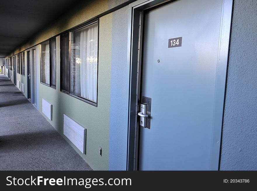 Exterior view of hotel room showing doors and windows.