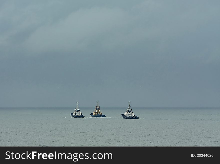 Three tub boats under power at sea. Three tub boats under power at sea.