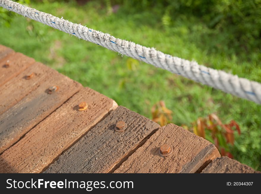 View of rope and nut head on wooden bridge. View of rope and nut head on wooden bridge