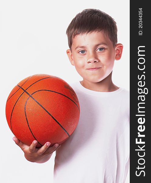 Boy in a white vest holds a ball for game in basketball. Boy in a white vest holds a ball for game in basketball.