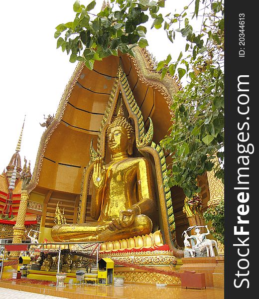 Massive golden Buddha in sitting pose with open palm in Kanchanaburi, Thailand. Massive golden Buddha in sitting pose with open palm in Kanchanaburi, Thailand.