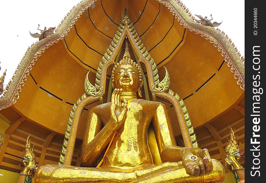 Massive golden Buddha in sitting pose with open palm in Kanchanaburi, Thailand. Massive golden Buddha in sitting pose with open palm in Kanchanaburi, Thailand.