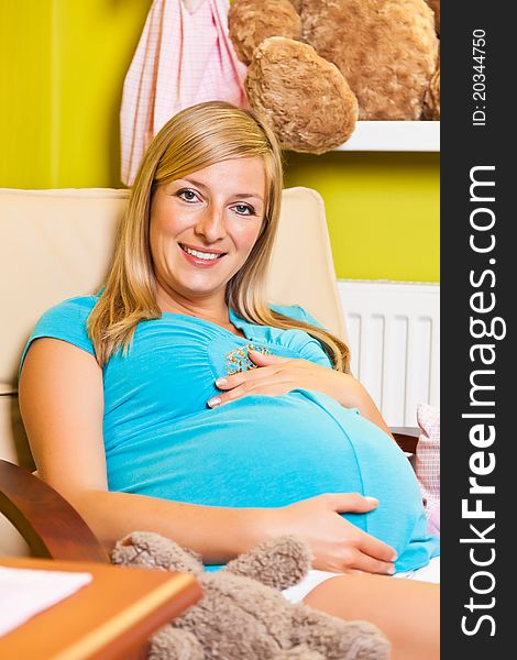 Pregnant woman in baby room