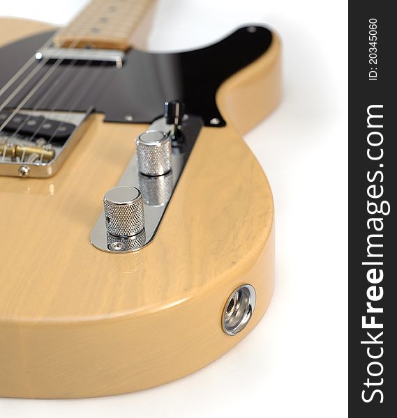 Photograph of a classic 1950s-style vintage American electric guitar with blonde finish, black pick guard, maple fretboard. Photograph of a classic 1950s-style vintage American electric guitar with blonde finish, black pick guard, maple fretboard.