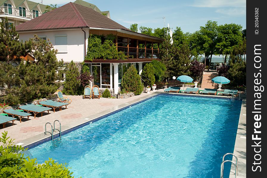 Swimming pool with tables for leisure travelers at the hotel