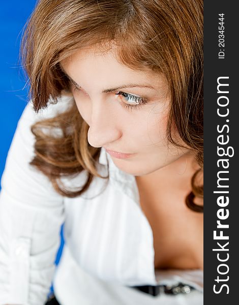 Portrait of young redhead woman with white shirt looking left. Portrait of young redhead woman with white shirt looking left