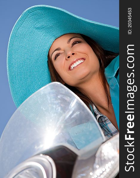 Happy female face with blue hat smilling on moped. Happy female face with blue hat smilling on moped