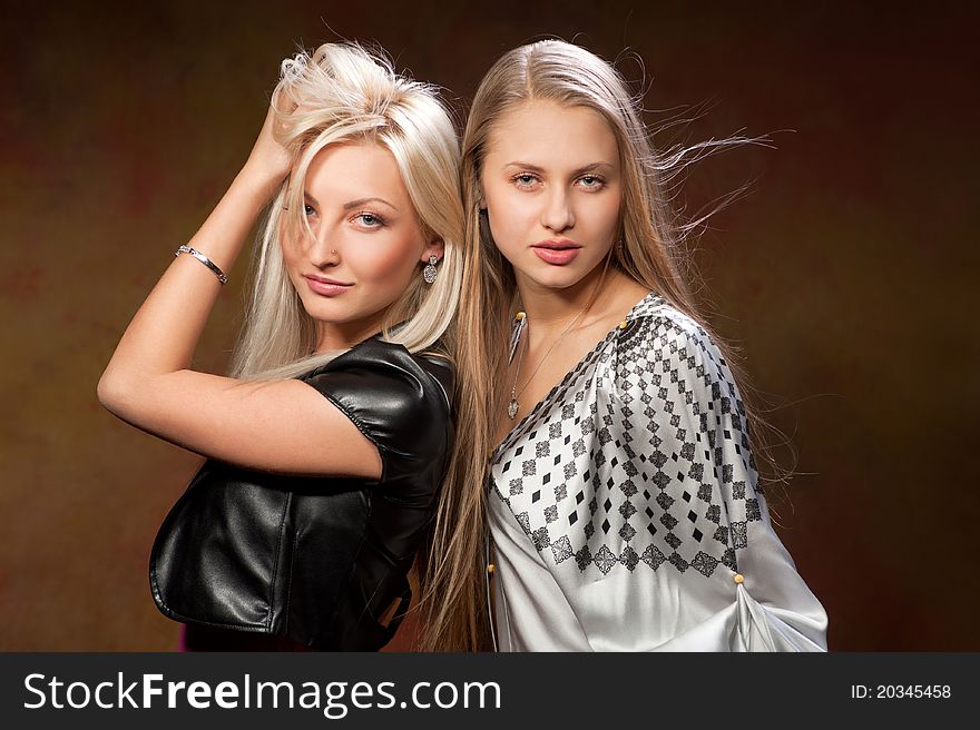 Two beautiful women on a colored background