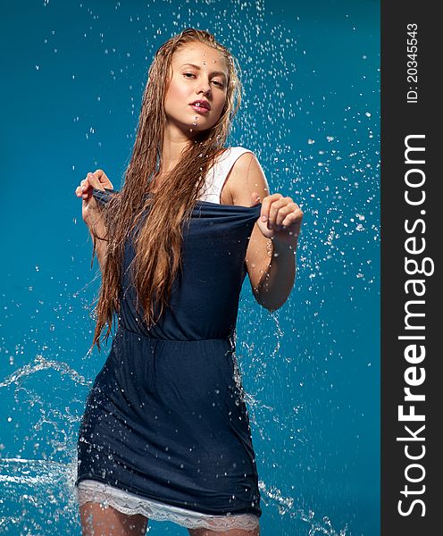 Woman in a blue dress with running water. Woman in a blue dress with running water