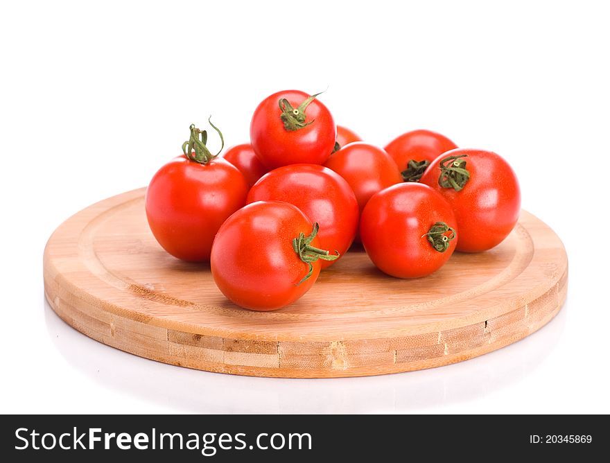 A bunch of tomatoes on board over white background