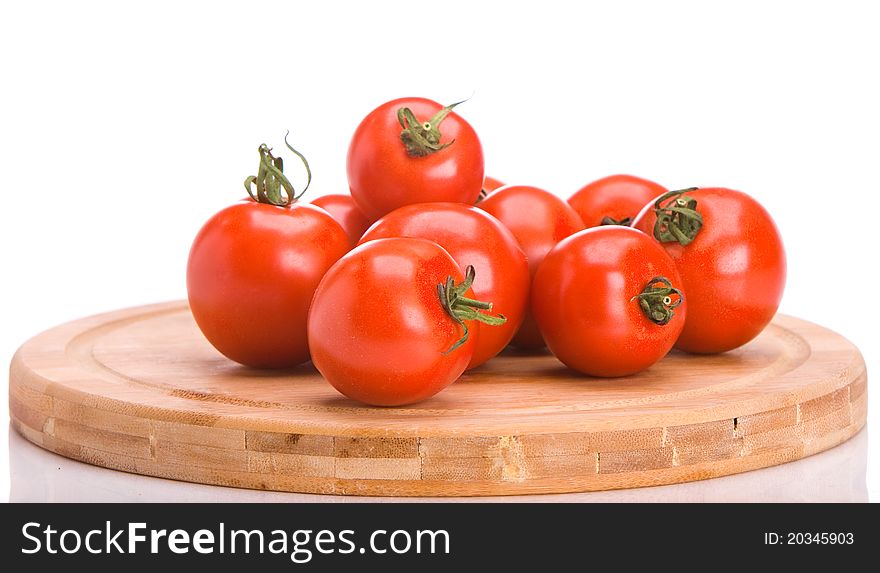 A bunch of tomatoes on board over white background