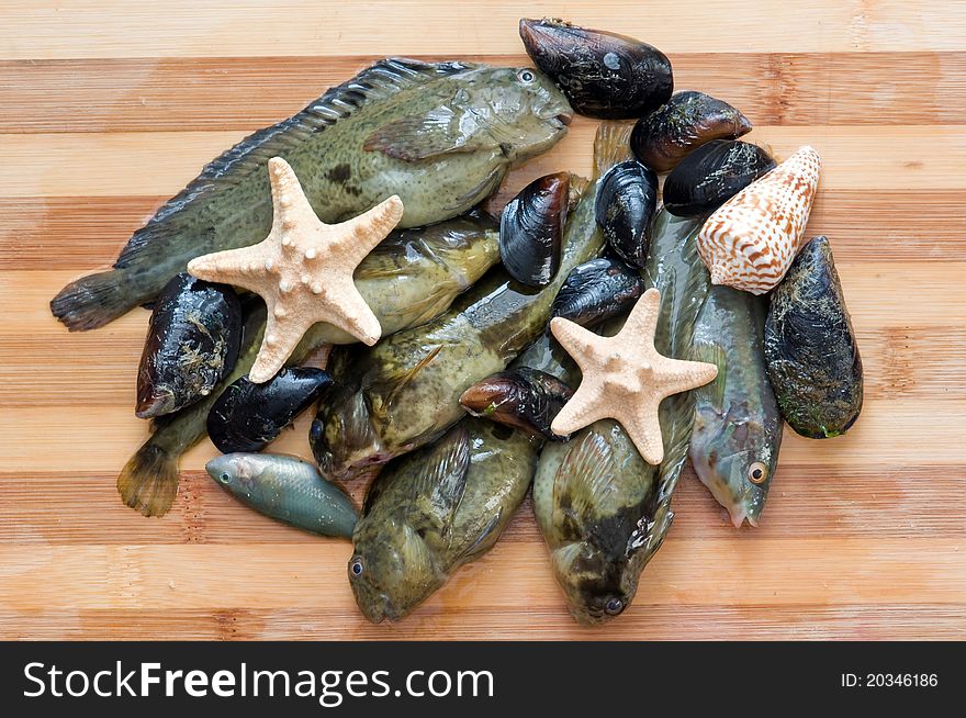 Fresh fish and mussels on wood table. Fresh fish and mussels on wood table