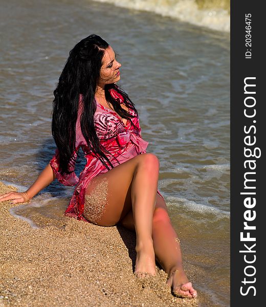 Beautiful woman sitting on the beach