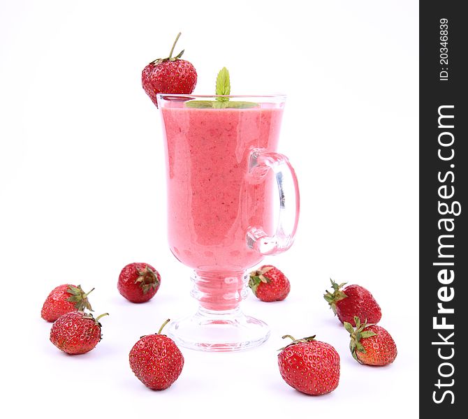 Strawberry shake in a glass decorated with strawberries and mint