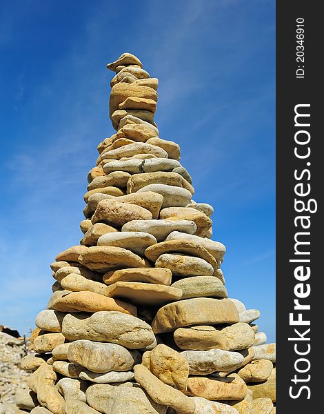 Pile of pebble as the tower against the background of sky. Pile of pebble as the tower against the background of sky