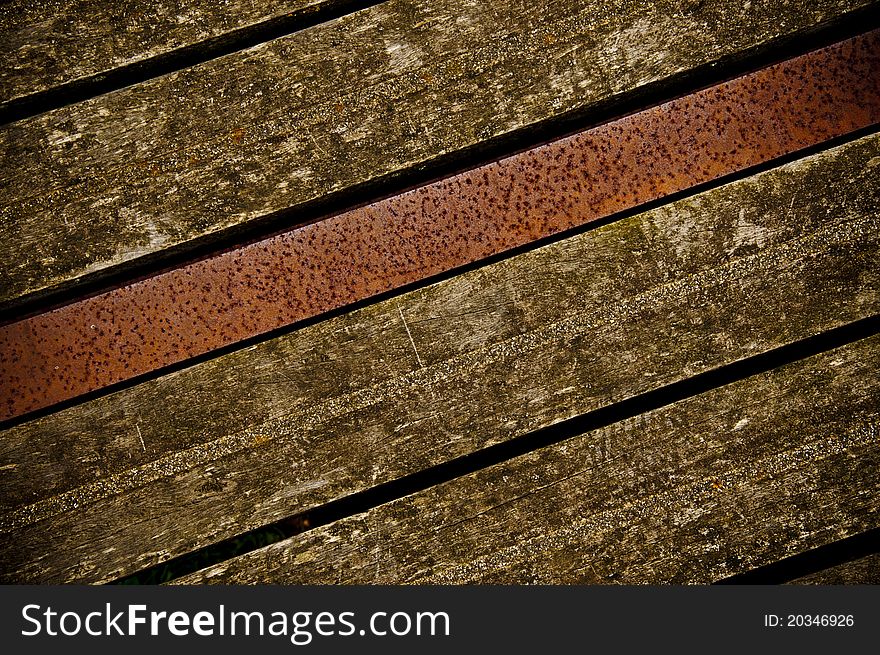 Old wooden boards on a bridge with metal beam in middle. Old wooden boards on a bridge with metal beam in middle