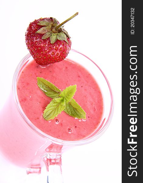 Strawberry shake in a glass with a strawberry and mint