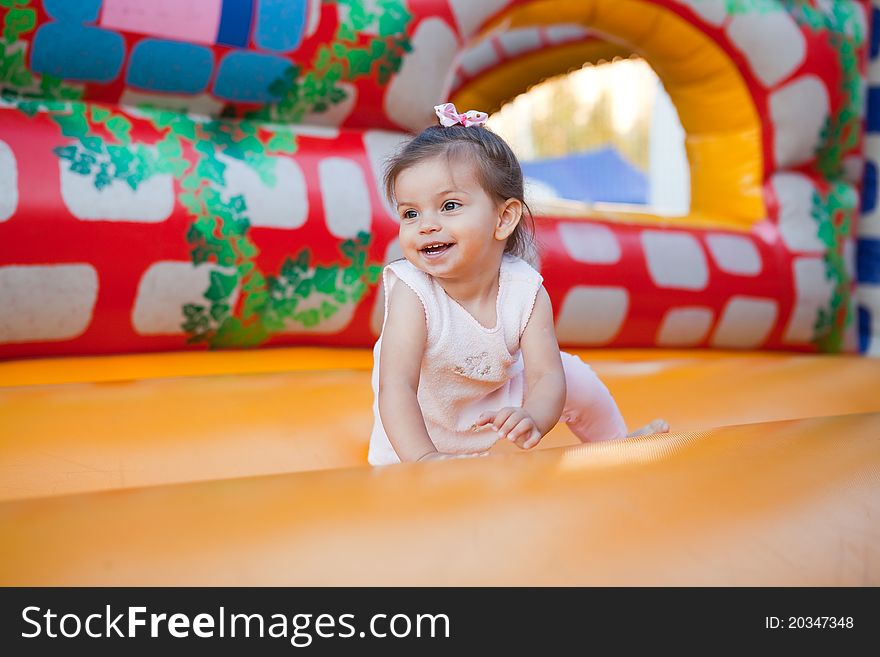 Happy child jumping on trampoline outdoors