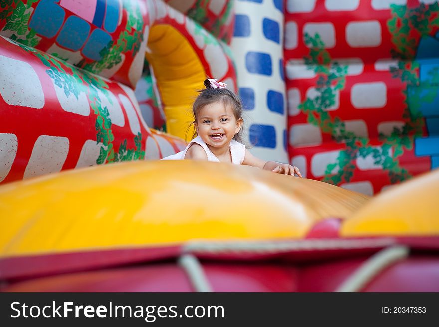 Happy child jumping on trampoline outdoors