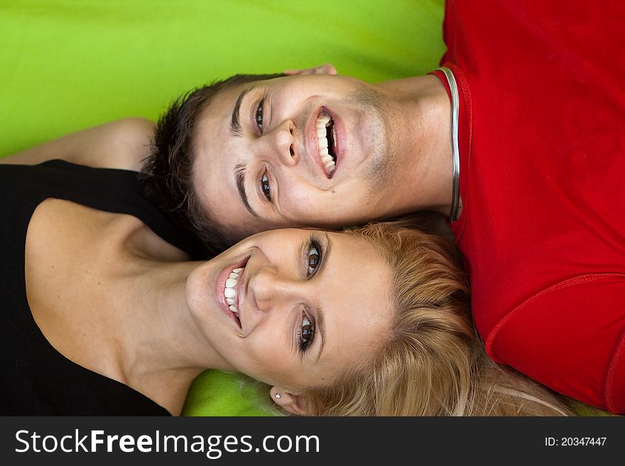 Closeup portrait of a joyful young couple laughing together