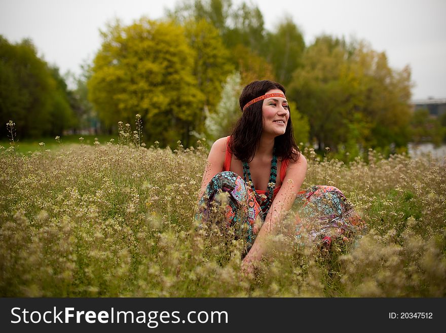 Girl Sitting In An Autumn Field