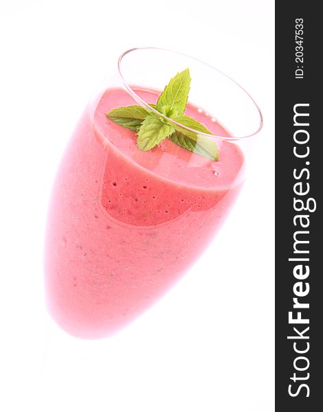 Strawberry shake in a champagne glass decorated with mint twig