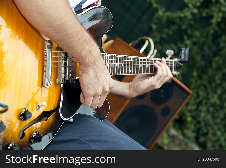 Hands of a musician who plays electric guitar