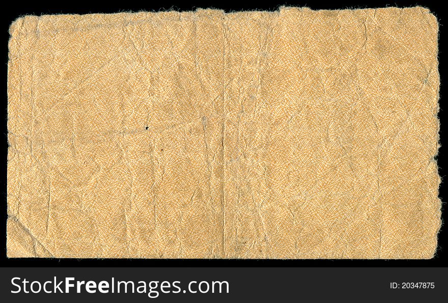 A piece of old yellow paper with ragged edges on a black background. A piece of old yellow paper with ragged edges on a black background