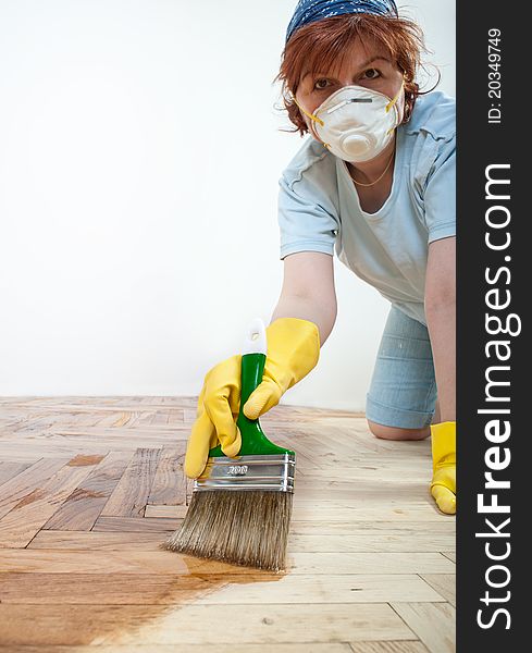 Mid adult women painting the floor. Mid adult women painting the floor