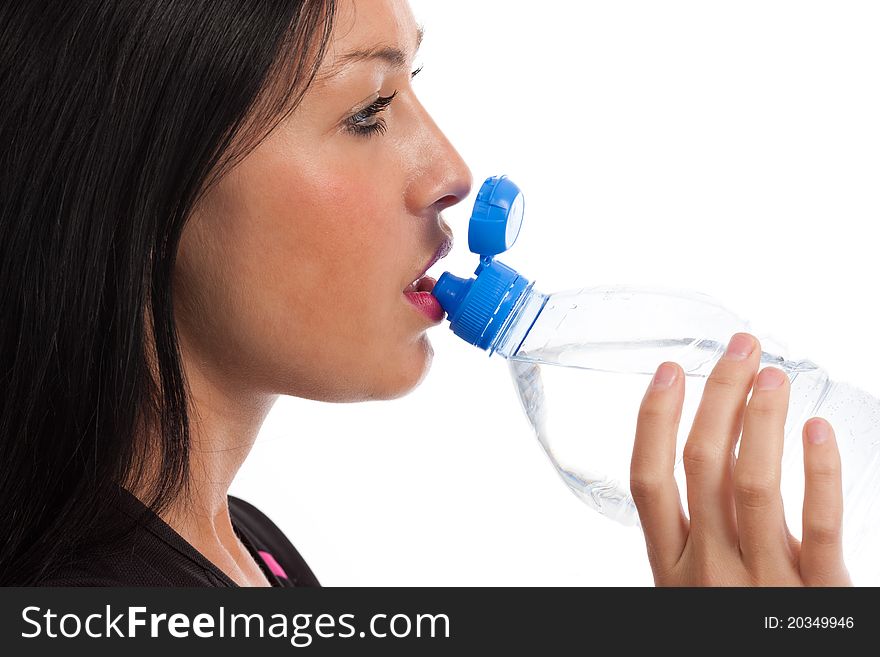 A close up of a gril drinking water from a bottle. A close up of a gril drinking water from a bottle