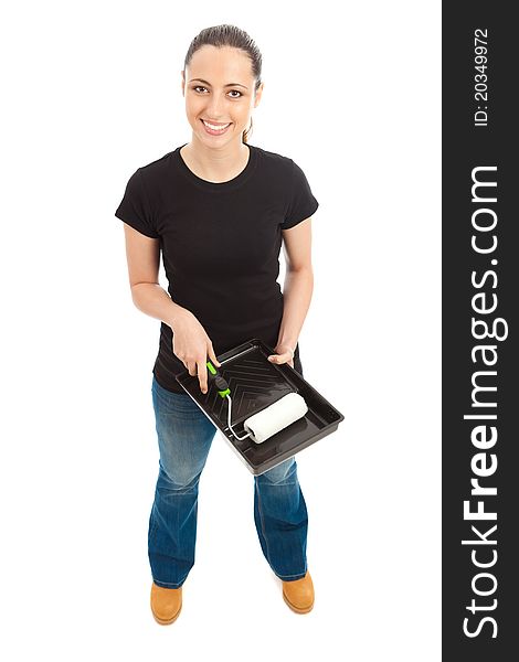 A young female dressed in a black t shirt and blue jeans holding a paint roller and tray. A young female dressed in a black t shirt and blue jeans holding a paint roller and tray