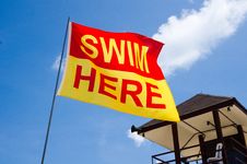 Swim Here Flag Next To Lifeguard House Stock Photos Swim Here Flag Next To Lifeguard House Stock Photos
