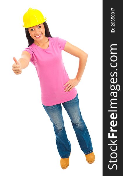 A young female dressed in blue jeans and pink top and yellow hard hat giving the thumbs up sign. A young female dressed in blue jeans and pink top and yellow hard hat giving the thumbs up sign