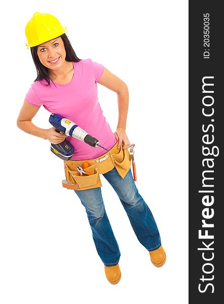 A young female dressed in blue jeans and pink top and yellow hard hat holding a cordless drill. A young female dressed in blue jeans and pink top and yellow hard hat holding a cordless drill