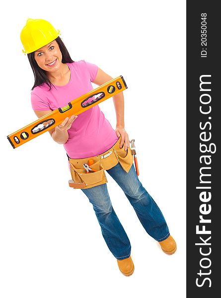 A young female dressed in blue jeans and pink top  and yellow hard hat holding a spirit level. A young female dressed in blue jeans and pink top  and yellow hard hat holding a spirit level