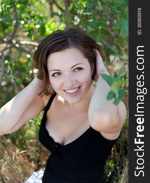 Portrait of the young beautiful smiling woman outdoors