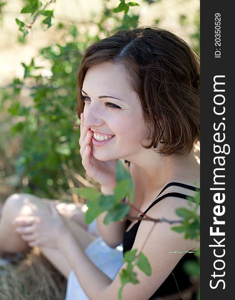 Portrait of the young beautiful smiling woman outdoors