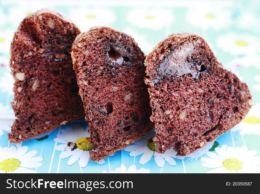 Egg white,nuts,cocoa and chocolate cake on a daisy background. Egg white,nuts,cocoa and chocolate cake on a daisy background