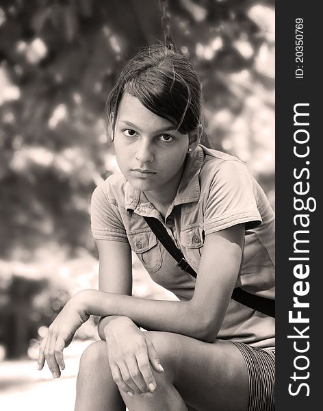 Teenage girl portrait sitting outdoor in black and white