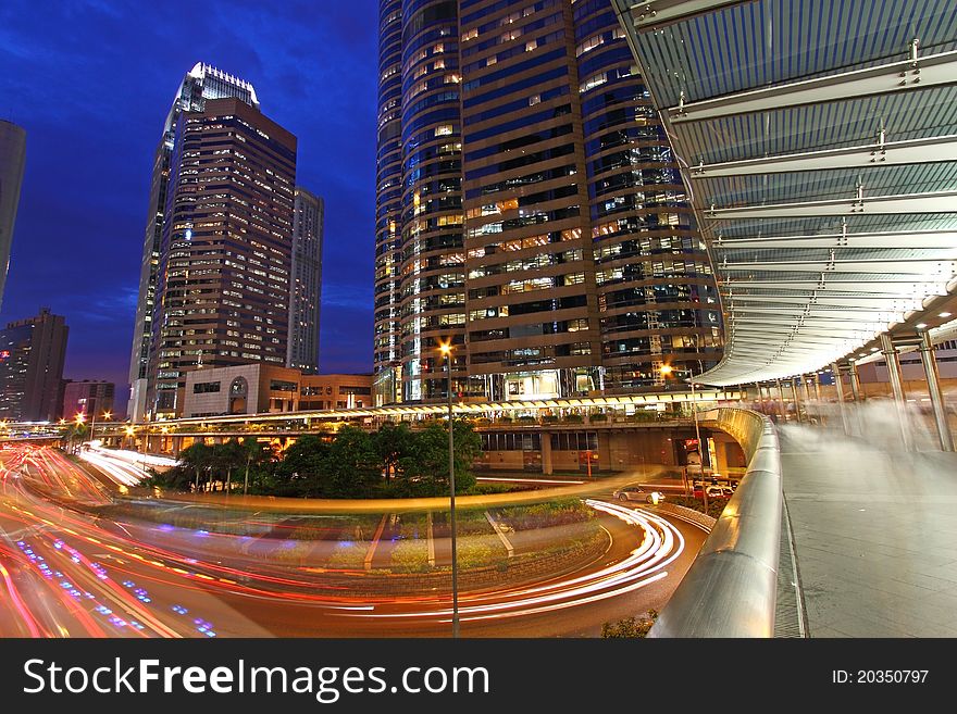 It shows the busy traffic in Hong Kong at night with colorful trails. It shows the busy traffic in Hong Kong at night with colorful trails.